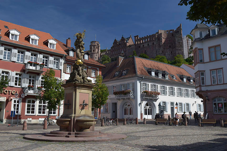 Heidelberg Castle and the Cornmarket from outside the Prinz Carl Hotel Photograph by David Hill taken 26 August 2015, 13.01 GMT Occasionally there is a record of exactly where Turner stayed on his travels. In 1995 Cecilia Powell (Turner and Germany, p.74) discovered documentation that Turner stayed in the Prinz Carl Hotel on the Cornmarket at Heidelberg. A newspaper reported him there 24-27 August 1844. Powell also identified a sketch from a tour dated to 1840 of the view from his room. The building that Turner stayed in was demolished in the 1970s but was replaced by a building of similar footprint and general elevation. Lining up the angles from the opposite side of the square it is possible to pinpoint the exact position of Turner’s room. 